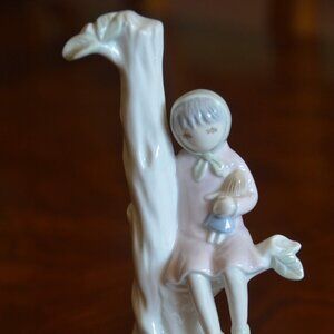 FLAVIA Porcelain Girl Figurine Sitting on Tree with Doll